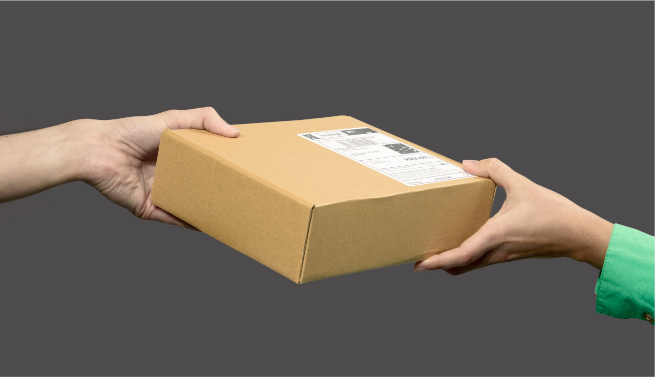 Hands handing off a parcel